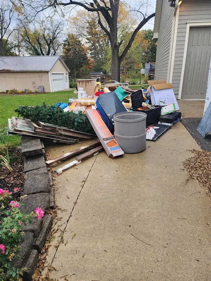 Dumpster being loaded with debris for Estate Cleanout Dumpster Rental in Heber